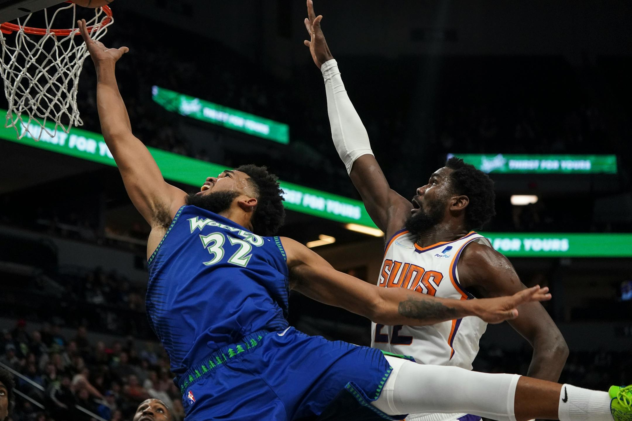 Minnesota Timberwolves center Karl-Anthony Towns (32) makes a shot as Phoenix Suns center Deandre Ayton (22) guards him in the third quarter.