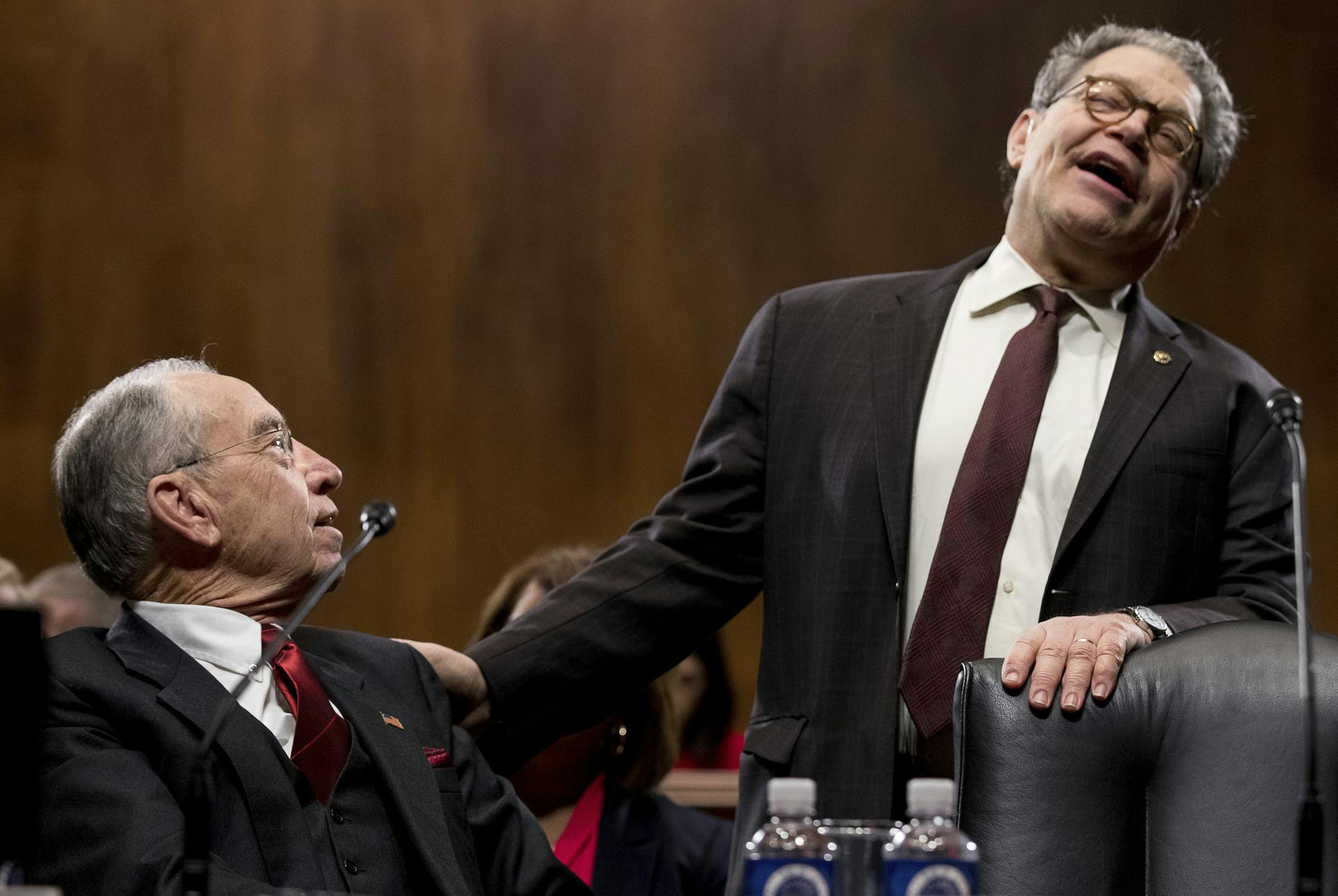 Senate Judiciary Committee member Sen. Al Franken, D-Minn., right, reacts as he speaks with the committee's chairman Sen. Charles Grassley, R-Iowa, on Capitol Hill in Washington, Tuesday, Jan. 31, 2017, before the committee's business meeting to discuss the nomination of Attorney General-designate, Sen. Jeff Sessions, R-Ala. (AP Photo/Andrew Harnik)