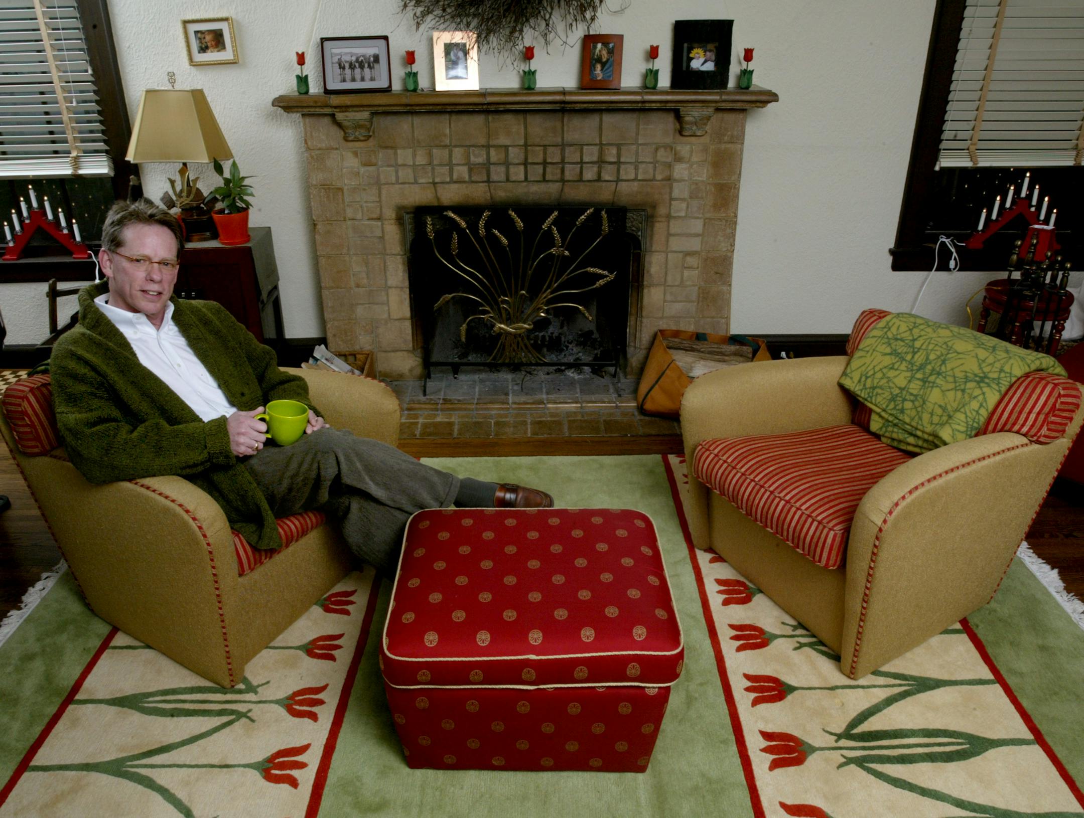 Cotty Lowry in his Lake Harriet living room. His wife, textile artist Laurie Jacobi, designed the rug and the wool blanket draped on the chair at right.