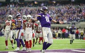 Minnesota Vikings quarterback Kirk Cousins prances into the end zone untouched on a 7-yard touchdown run in the third quarter against the Arizona Card
