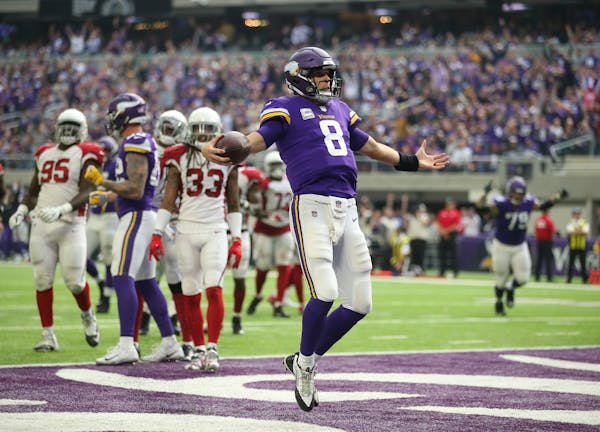 Minnesota Vikings quarterback Kirk Cousins prances into the end zone untouched on a 7-yard touchdown run in the third quarter against the Arizona Card