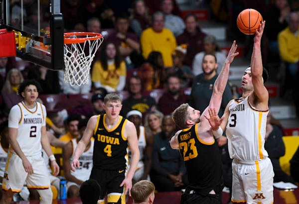 Gophers forward Dawson Garcia (3) scored against Iowa forward Ben Krikke (23) in the second half of Monday’s game at Williams Arena.