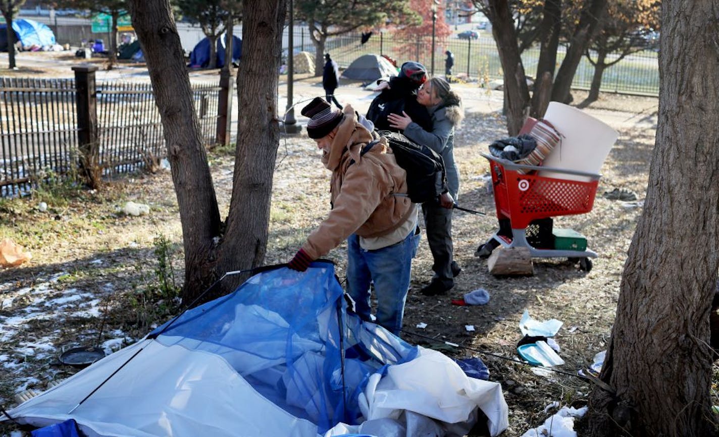 St. Paul officials began clearing out the St. Paul homeless near the Cathedral of St. Paul Wednesday, Nov. 15, 2018, in St. Paul, MN. Here, George Gonzalez packed up his tent as homeless advocate Sara Hejny, hugged Derrick Hutchison, who was formerly homeless and came to help people pack.