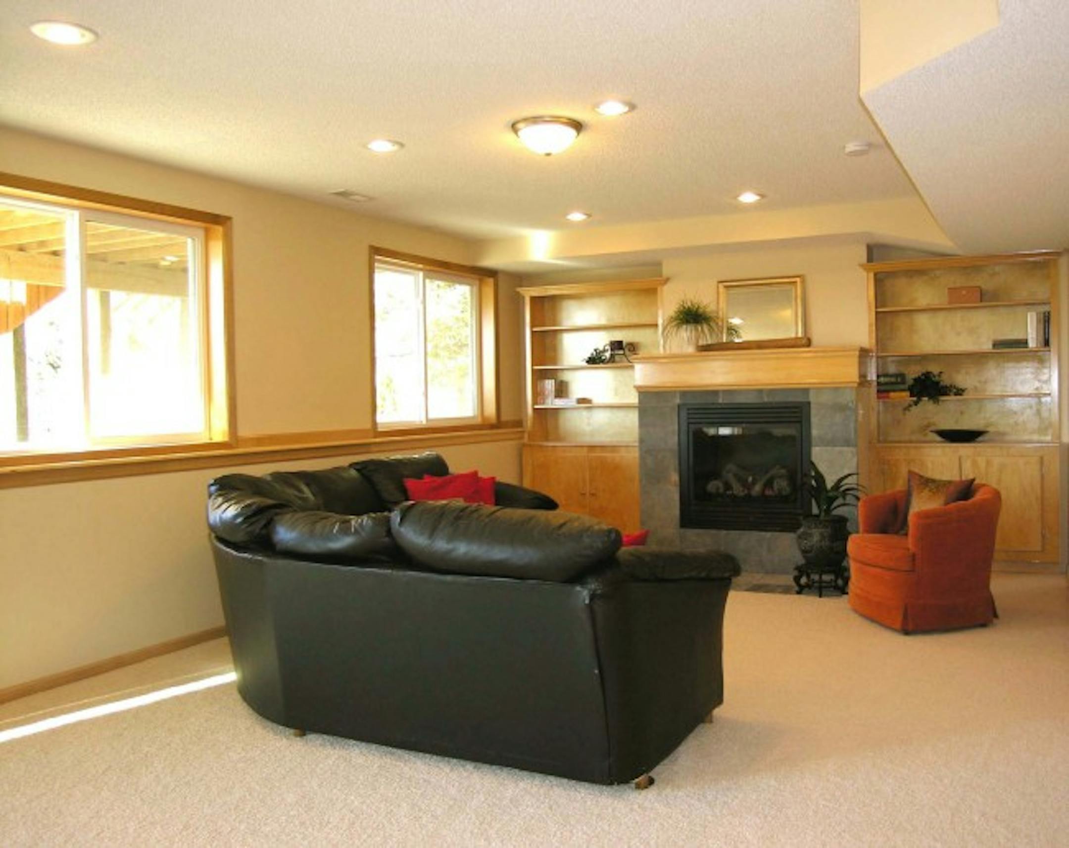 After: Removing outdoor decor stored in the room and positioning furniture in front of the fireplace gives the room scale and purpose.