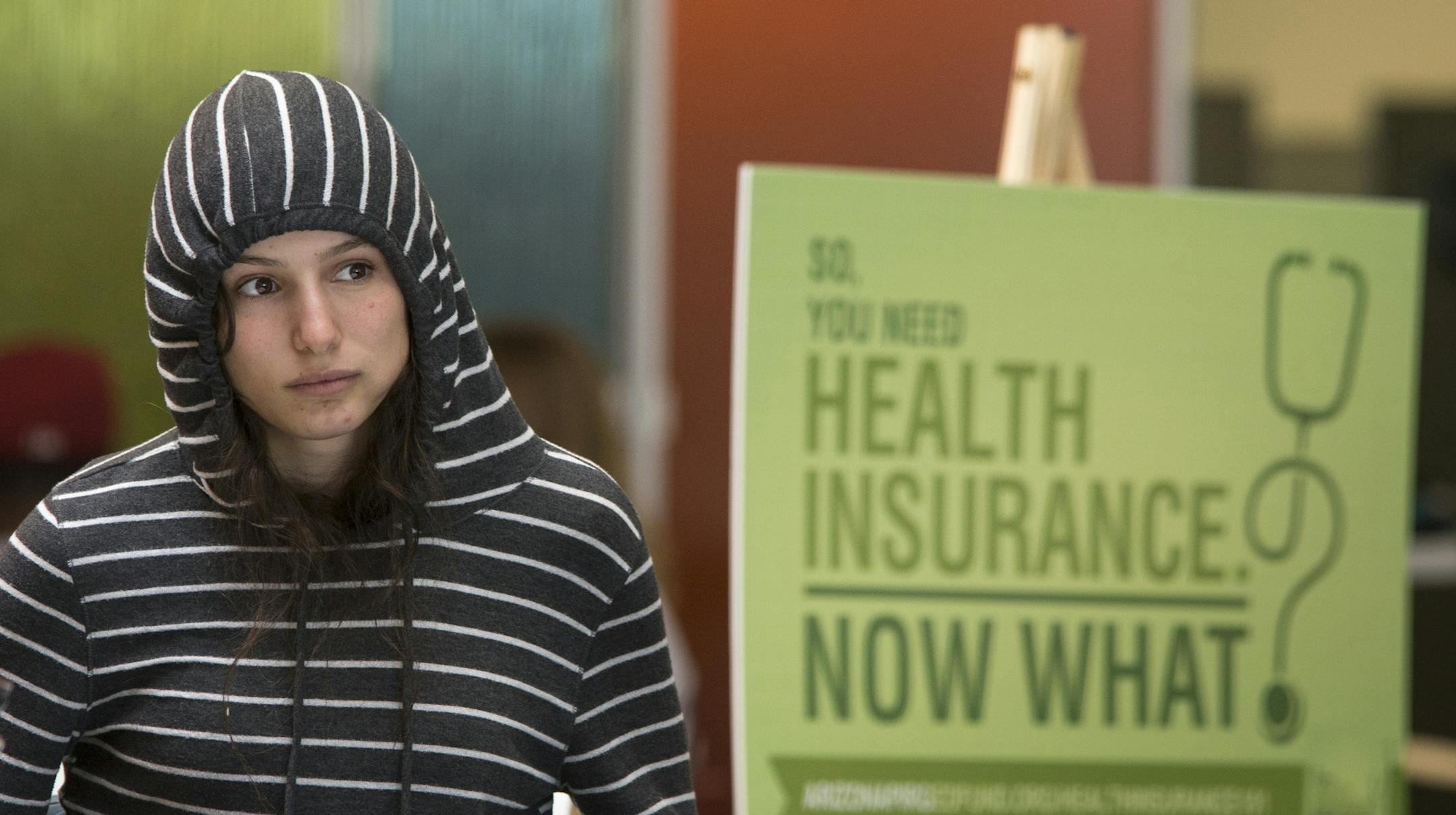 FILE - In this Tuesday Oct. 1, 2013, file photo, Phoenix College freshman Willow Kanowshy listens during an Affordable Care Act information session in the student union at Phoenix College, in Phoenix. The pressure is on for the federal government and states running their own health insurance exchanges to get their systems up and running after overloaded websites and jammed phone lines frustrated consumers on Tuesday, the first day they could sign up for insurance under the federal health overhau