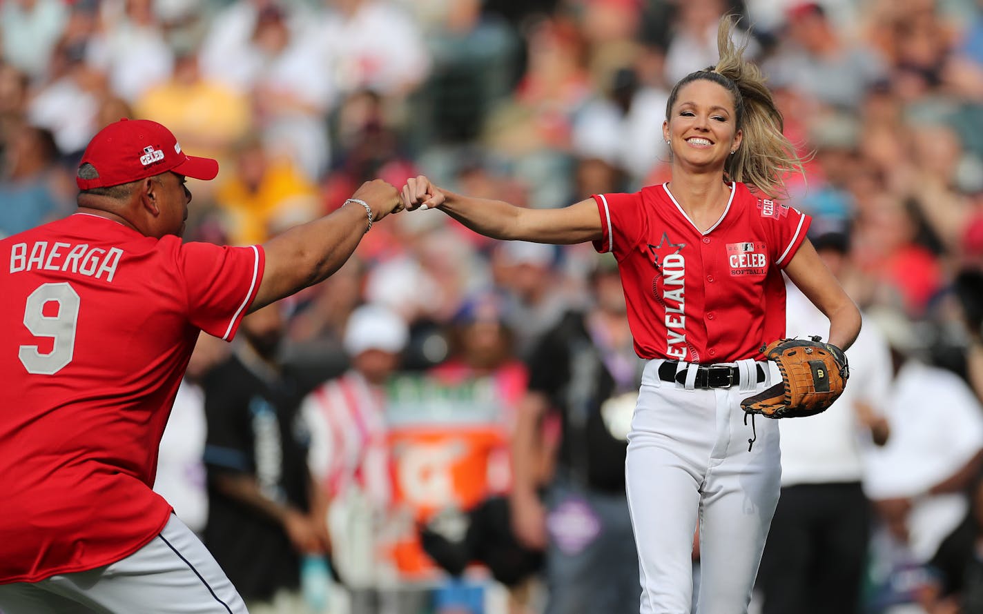 Broadcaster Allie LaForce gets a fist bump from Carlos Baerga after a great catch at first for an out during the MLB All-Star Celebrity Softball Game. \rJoshua Gunter, cleveland.com