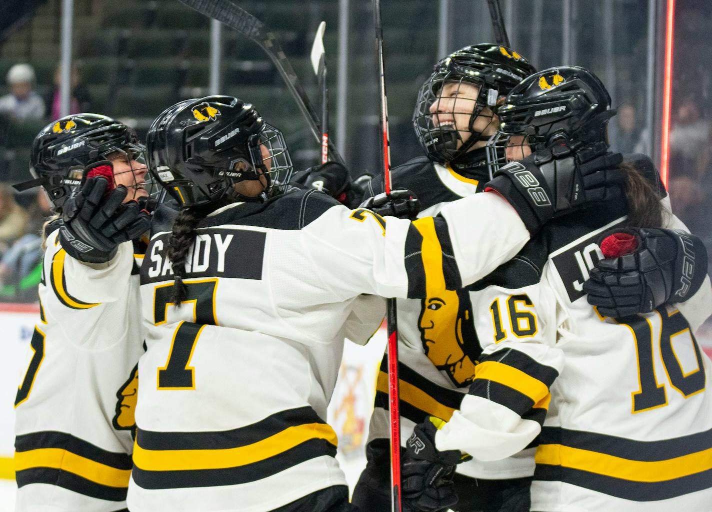 Warroad forward Rylee Bartz (6) is embraced by her teammates after scoring a goal in the first period of the Class 1A girl's hockey championship Saturday, Feb. 25, 2023 at Xcel Energy Arena in St. Paul. ]