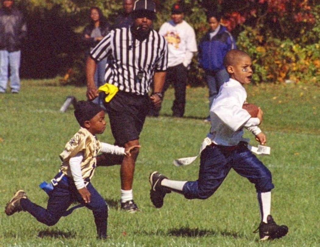 Darrisaw, right, towered over other kids in flag football at age 7.  