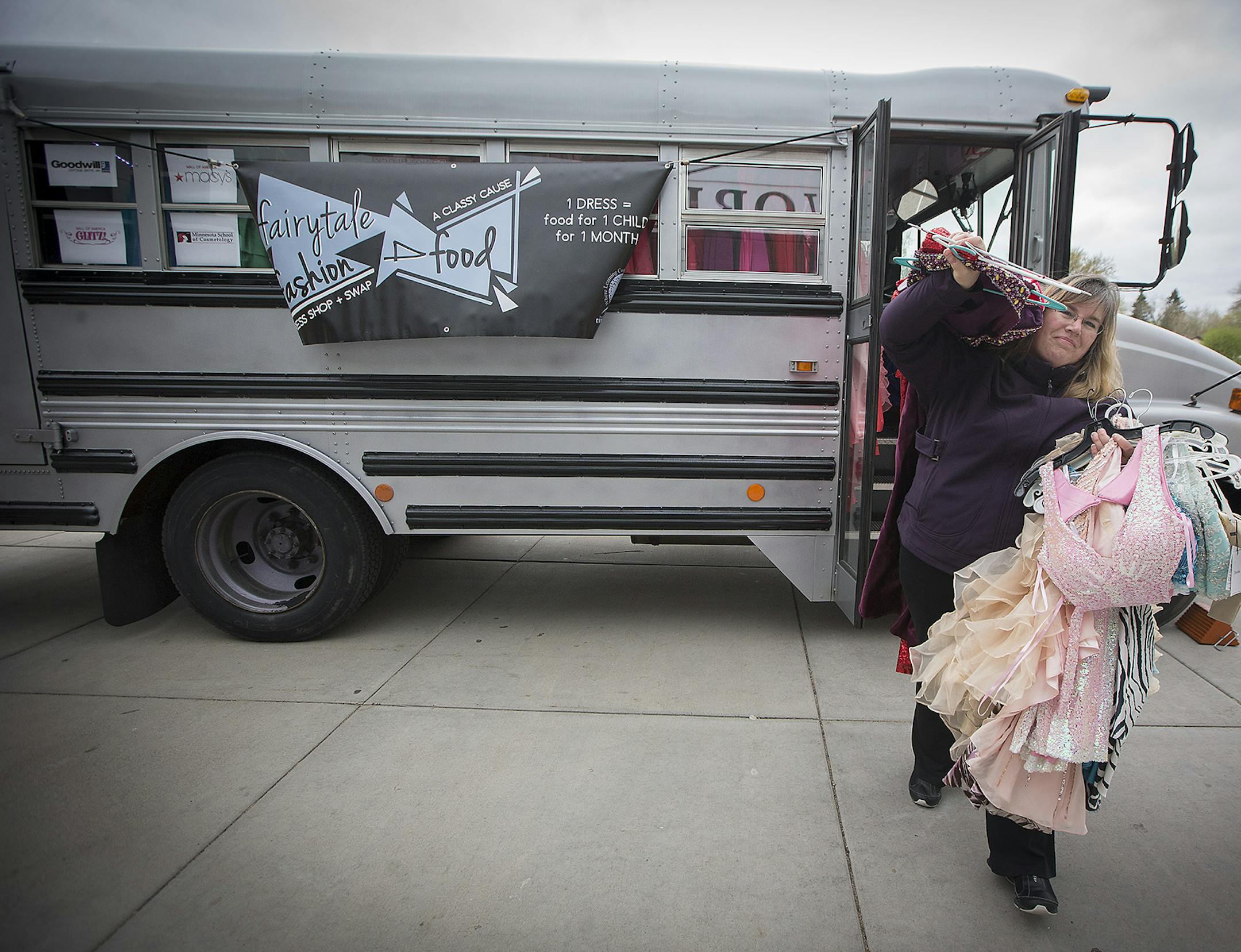 Diane Thielen made her way off the Prom Dress Swap and Shop (Fairytale Fashions for Food), bus with a load of dresses at Park High School, Thursday, April 27, 2017 in Cottage Grove, MN. ] ELIZABETH FLORES ï liz.flores@startribune.com