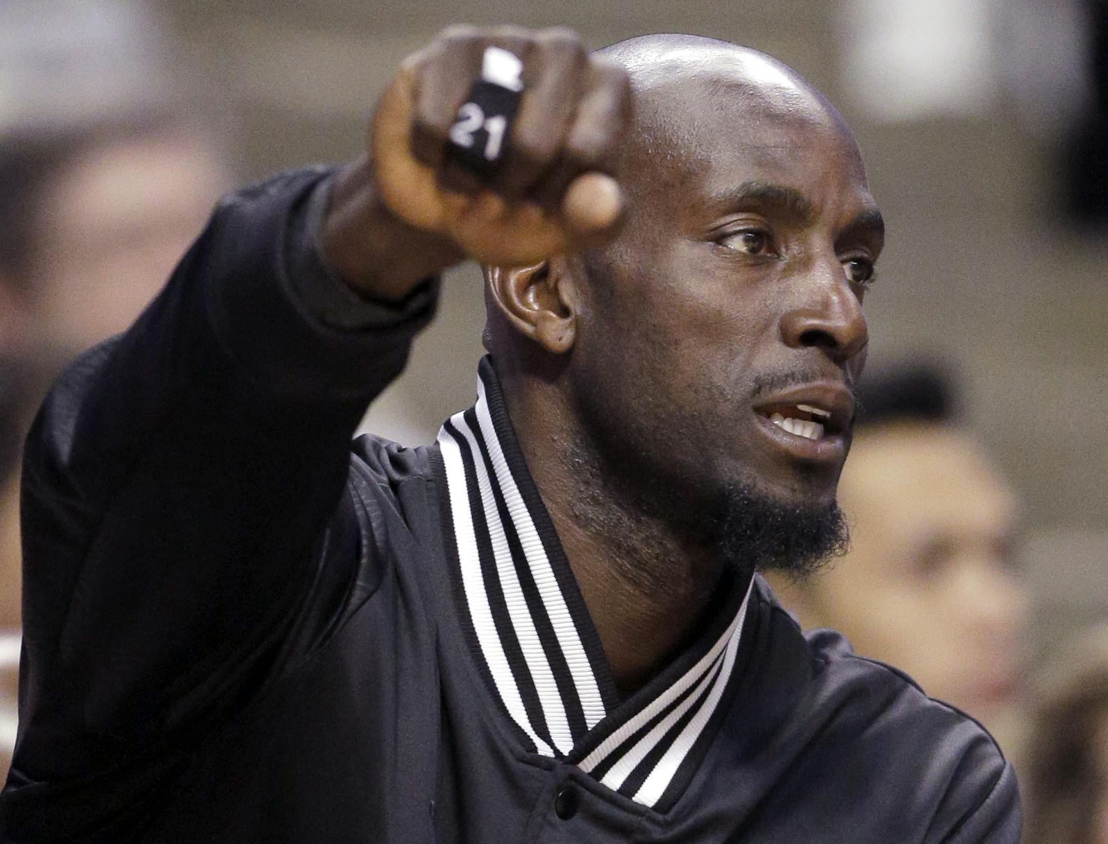 Minnesota Timberwolves forward Kevin Garnett (21) sits on the bench as he cheers for teammates during the first half of an NBA basketball game against the Chicago Bulls in Chicago on Friday, Feb. 27, 2015. (AP Photo/Nam Y. Huh)