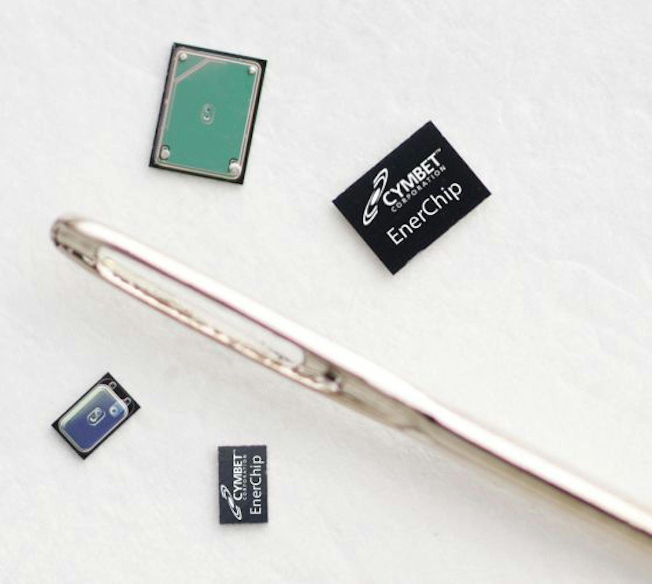 The eye of a needle compared with Cymbet's Enerchips with logos.