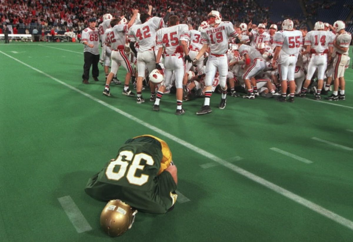 Dejected Jeremy Fenske of Rochester Mayo planted his face in the turf after his team lost the Class AA championship to Stillwater in 1995.