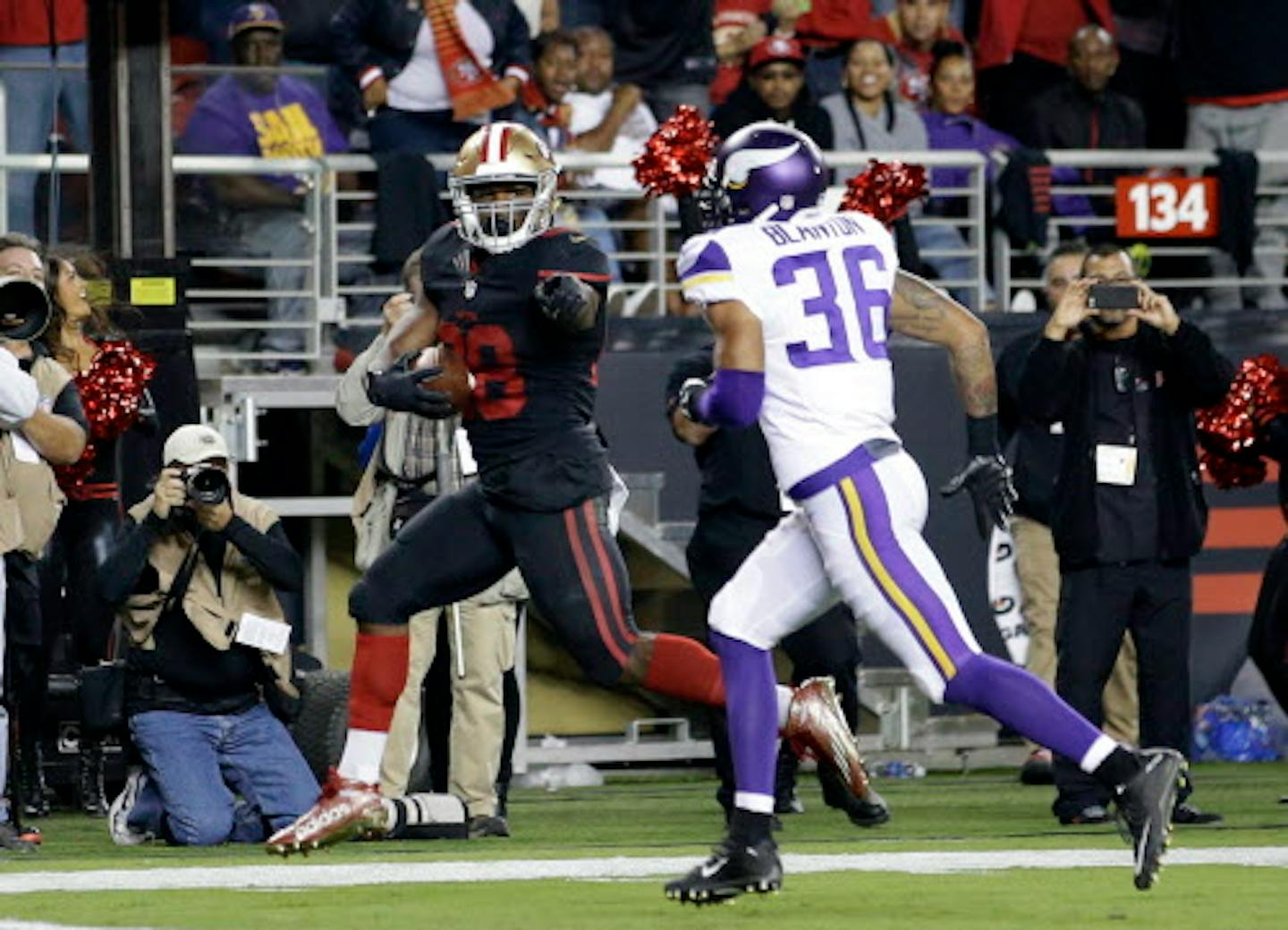 San Francisco 49ers running back Carlos Hyde, left, scores past Minnesota Vikings' Robert Blanton (36) during an NFL football game against the Minnesota Vikings in Santa Clara, Calif., Monday, Sept. 14, 2015. (AP Photo/Marcio Jose Sanchez)