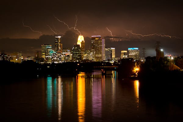 Lightning seen from the Lowry Avenue Bridge illuminated the sky above downtown Minneapolis on Friday night.