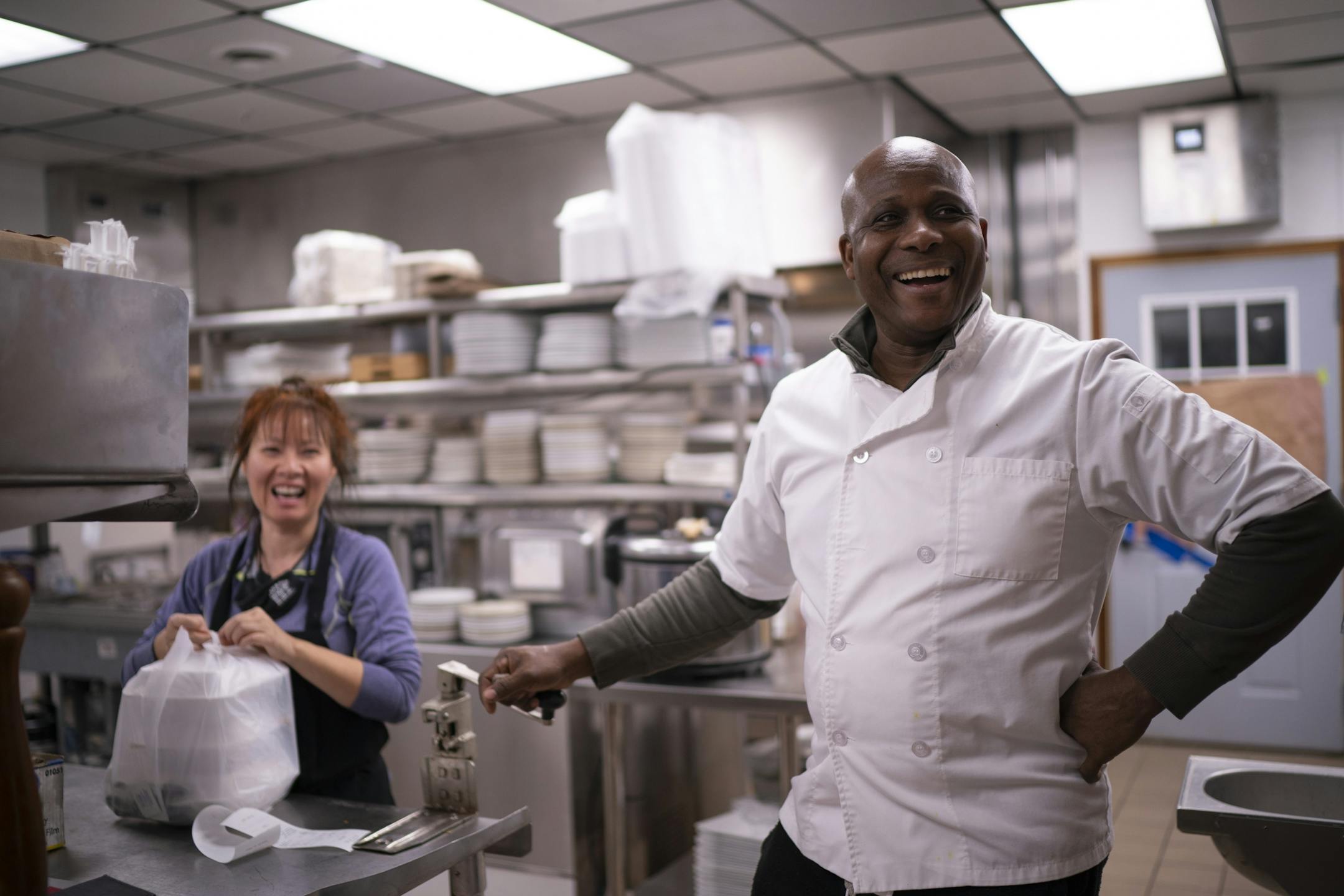 Club 300 co-owners Rowan Brown and Von Inthisone chatted with a customer while they put together a takeout order Thursday night.