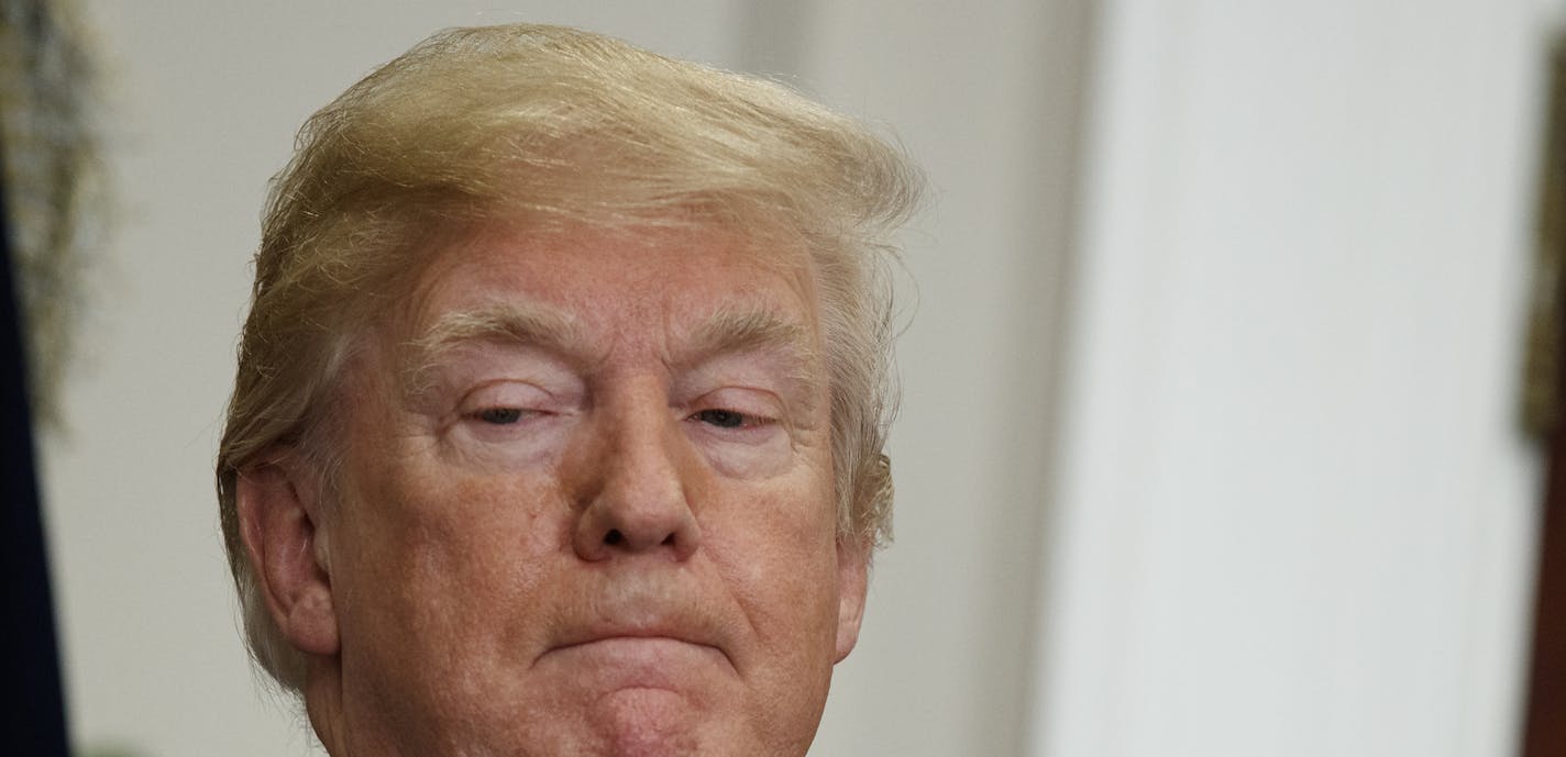 President Donald Trump listens as Secretary of Housing and Urban Development Ben Carson speaks during an event to honor Dr. Martin Luther King Jr., in the Roosevelt Room of the White House, Friday, Jan. 12, 2018, in Washington. (AP Photo/Evan Vucci)