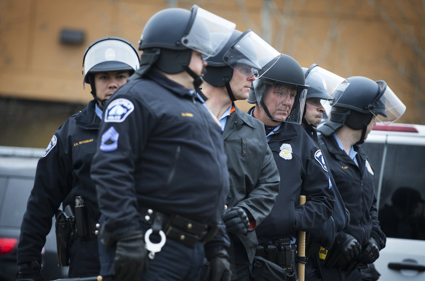 Police outfitted with helmets and sticks get ready to walk down Plymouth Avenue to the site where Jamar Clark was shot by Minneapolis Police, where a crowd has gathered and blocked Plymouth Avenue. ] (Leila Navidi/Star Tribune) leila.navidi@startribune.com BACKGROUND INFORMATION: Wednesday, March 30, 2016. Tensions mount in Minneapolis following the announcement that there will be no charges against Minneapolis police officers in the shooting death of Jamar Clark.