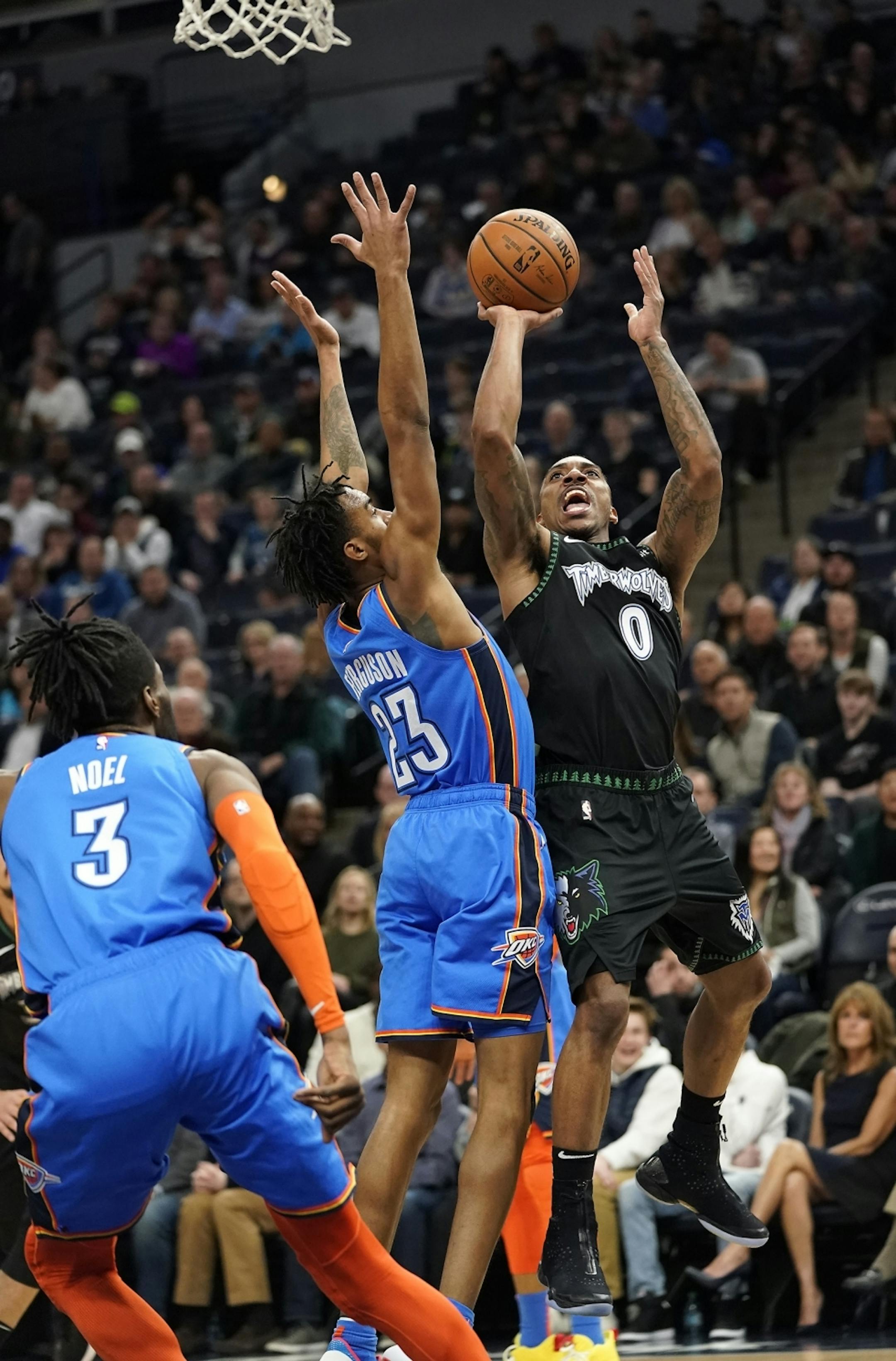 Minnesota Timberwolves guard Jeff Teague (0) shoots as Oklahoma City Thunder guard Terrance Ferguson (23) defends during the first half.