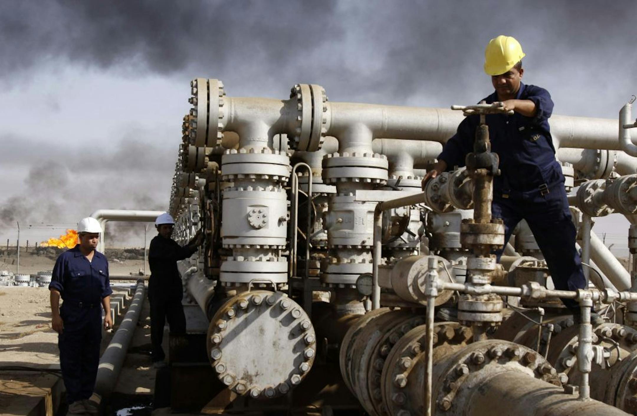 Iraqi workers in 2009 at the Rumaila oil refinery near Basra. Iraq's rapidly expanding oil production is likely to complicate OPEC's efforts to influence world prices as the country re-emerges as a major oil player after 20 years on the sidelines.