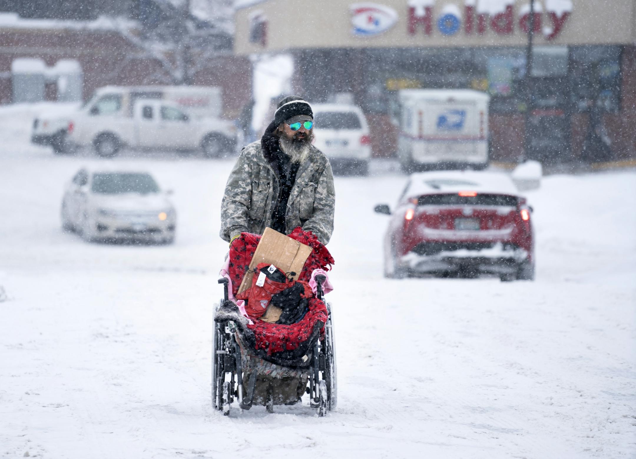 As the snow continued to pile up and pushed the metro area toward one of the snowiest Februarys on record, Homeless veteran Sgt. Daniel Boyle pushed his wheelchair through a snow packed parking lot after getting off the bus in Eagan Tuesday morning. Boyle, who struggles to walk, said getting around in a wheelchair is almost impossible after heavy snow. brian.peterson@startribune.com Eagan, MN Tuesday, February 12, 2019