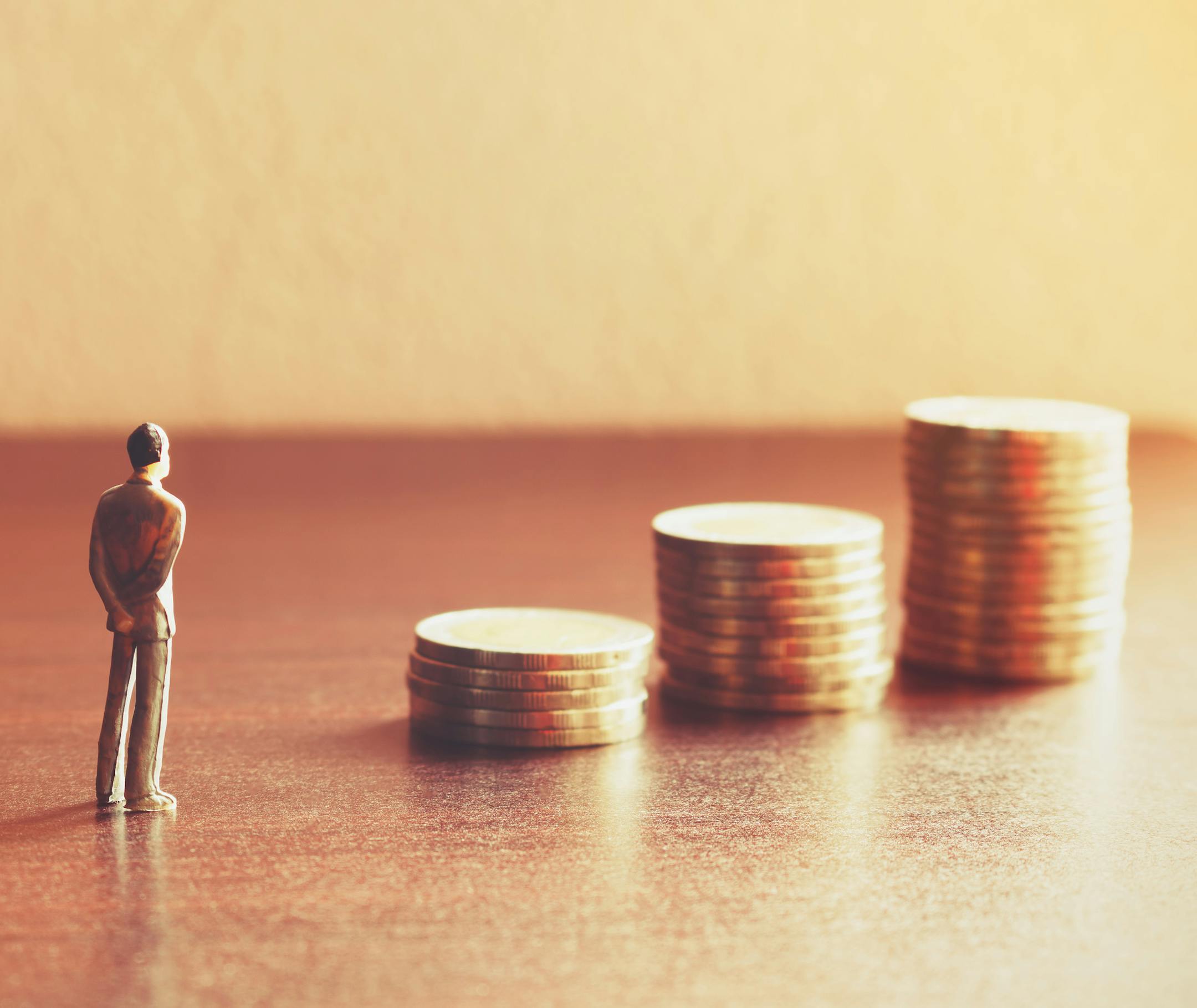 Miniature people looking future with stack coin about financial and money savings concept.