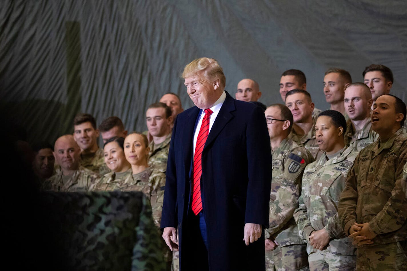 President Donald Trump with members of the military during a surprise Thanksgiving Day visit at Bagram Air Field, Afghanistan, Nov. 28, 2019.