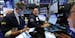 Specialist Anthony Matesic, center, works with traders at his post on the floor of the New York Stock Exchange, Wednesday, Aug. 21, 2019. Stocks are r