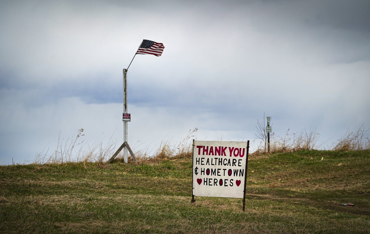 Along Hwy. 60 outside Wanamingo, Minn., stands two handmade signs across the road from each other. One says, "Thanks healthcare and hometown heroes"