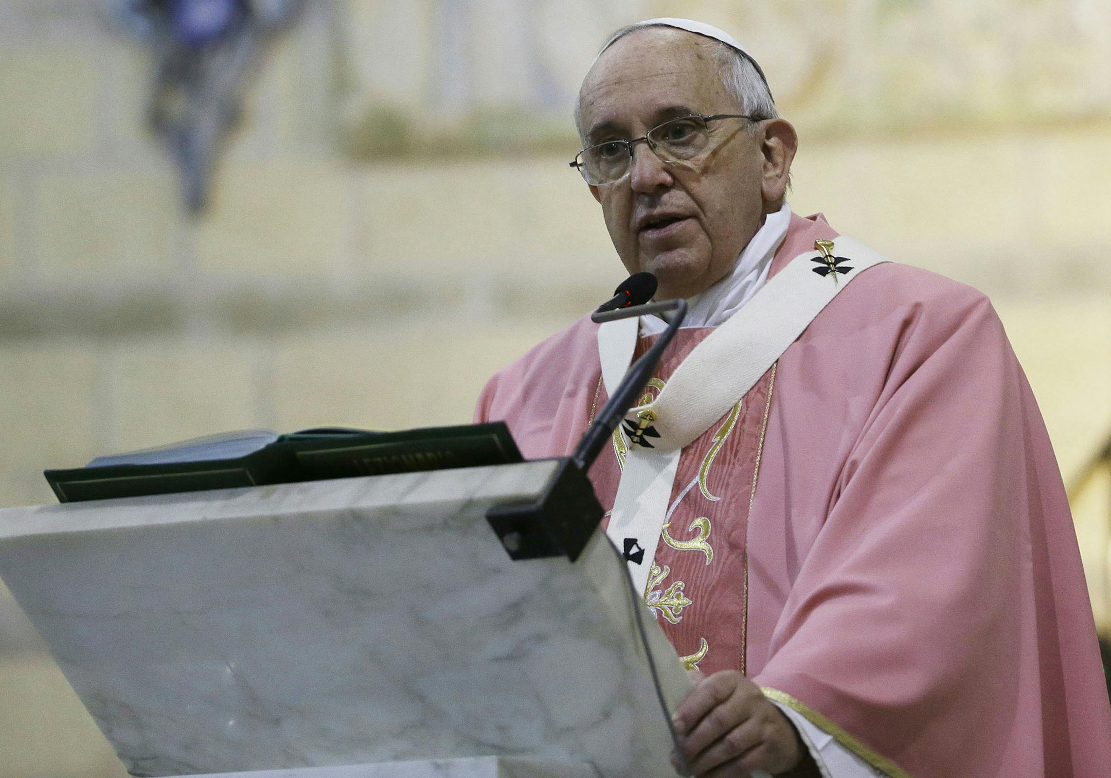 Pope Francis celebrates a Mass during his visit at the St. Joseph parish church in Rome, Sunday, Dec. 14, 2014. Greeting him when he arrived at the church was a handmade sign proclaiming in Italian, "Happy Birthday, Holiness" in brightly colored letters. Francis turns 78 on Wednesday. The pope told the parents of 60 infants who were baptized in the parish during 2014 that his own baptism took place on Christmas day in 1936. (AP Photo/Gregorio Borgia) ORG XMIT: MIN2014121713461363