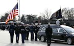 The flag-draped casket of former President George H.W. Bush is carried by a joint services military honor guard to Special Air Mission 41, Wednesday, 