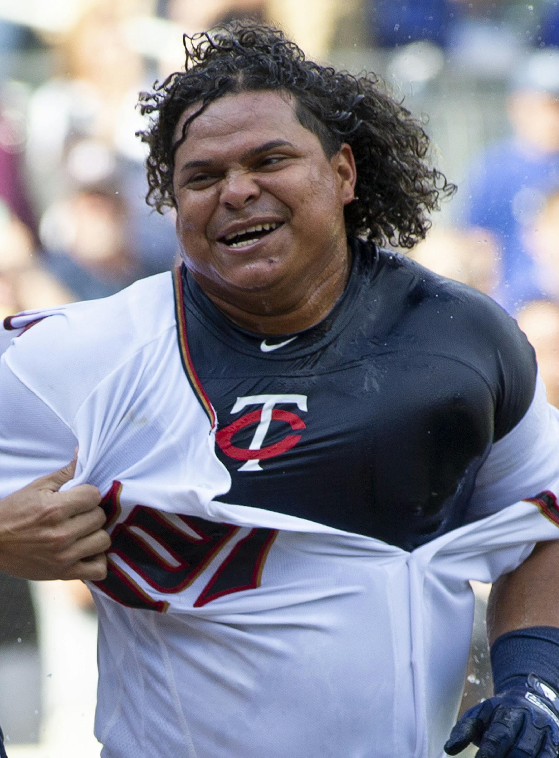 Minnesota Twins Willians Astudillo, right, is mobbed by teammate Jose Berrios after hitting a 2-run home run during the ninth inning of a baseball game against the Kansas City Royals, Sunday, Sept. 9, 2018, in Minneapolis. Minnesota won 3-1. (AP Photo/Paul Battaglia)
