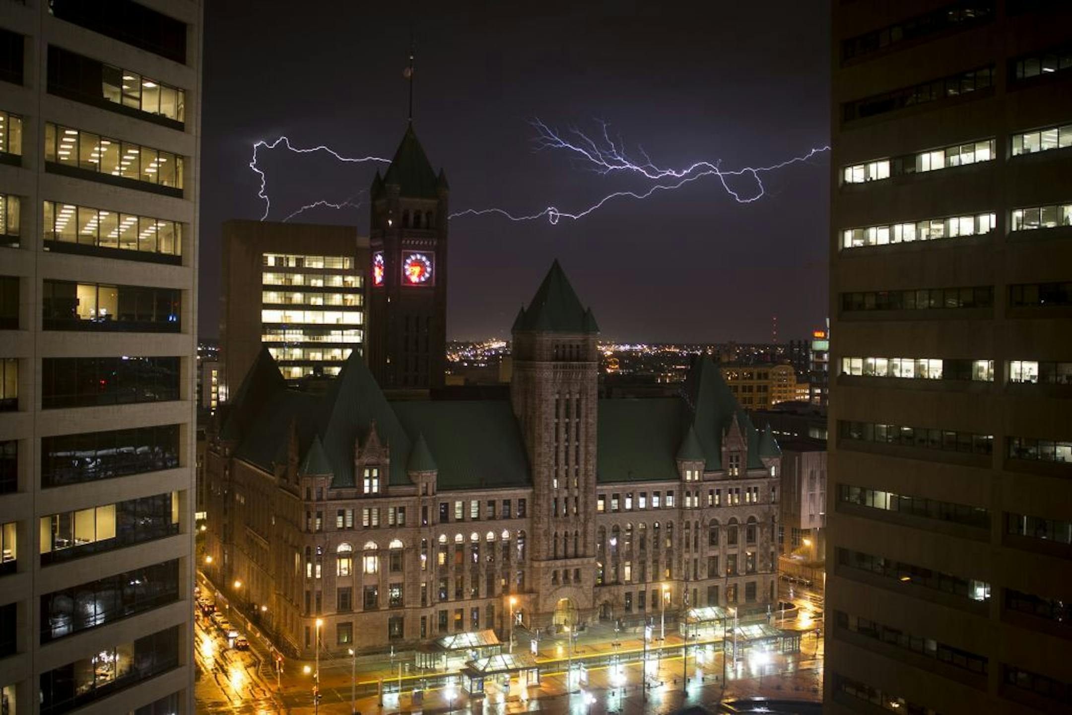 Lightning illuminates the sky behind City Hall on Wednesday, April 1, 2015 in Minneapolis.