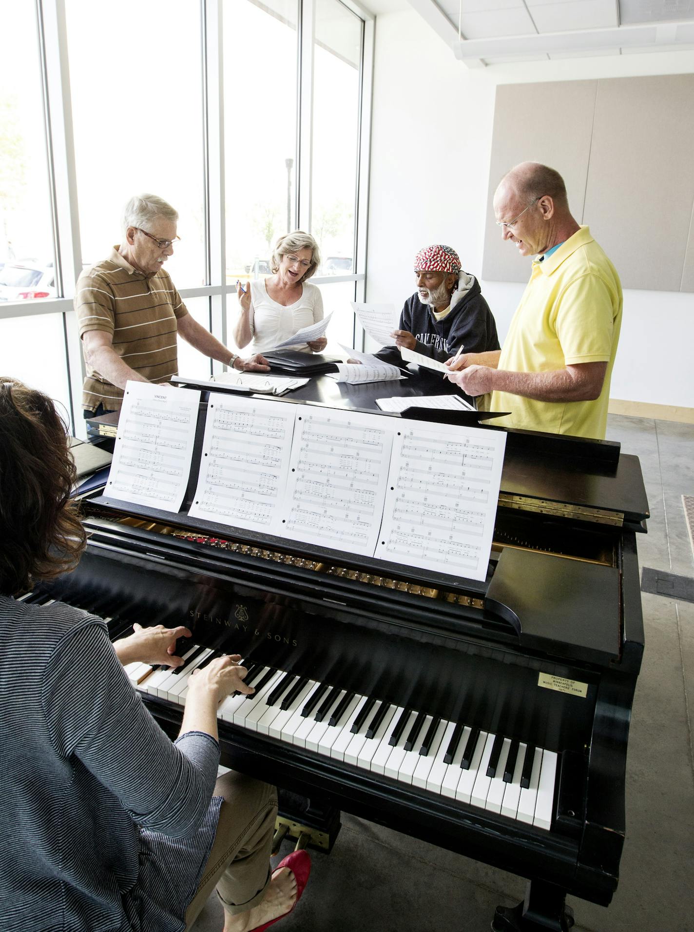 Standing left to right, Charles Reinhart, Cindy Dittmer, Krishna Seshan, and Gary Anderson work on a song in Andrea Leap's Singing Basics class at MacPhail Center for Music in Minneapolis July 15, 2014. (Courtney Perry/Special to the Star Tribune)