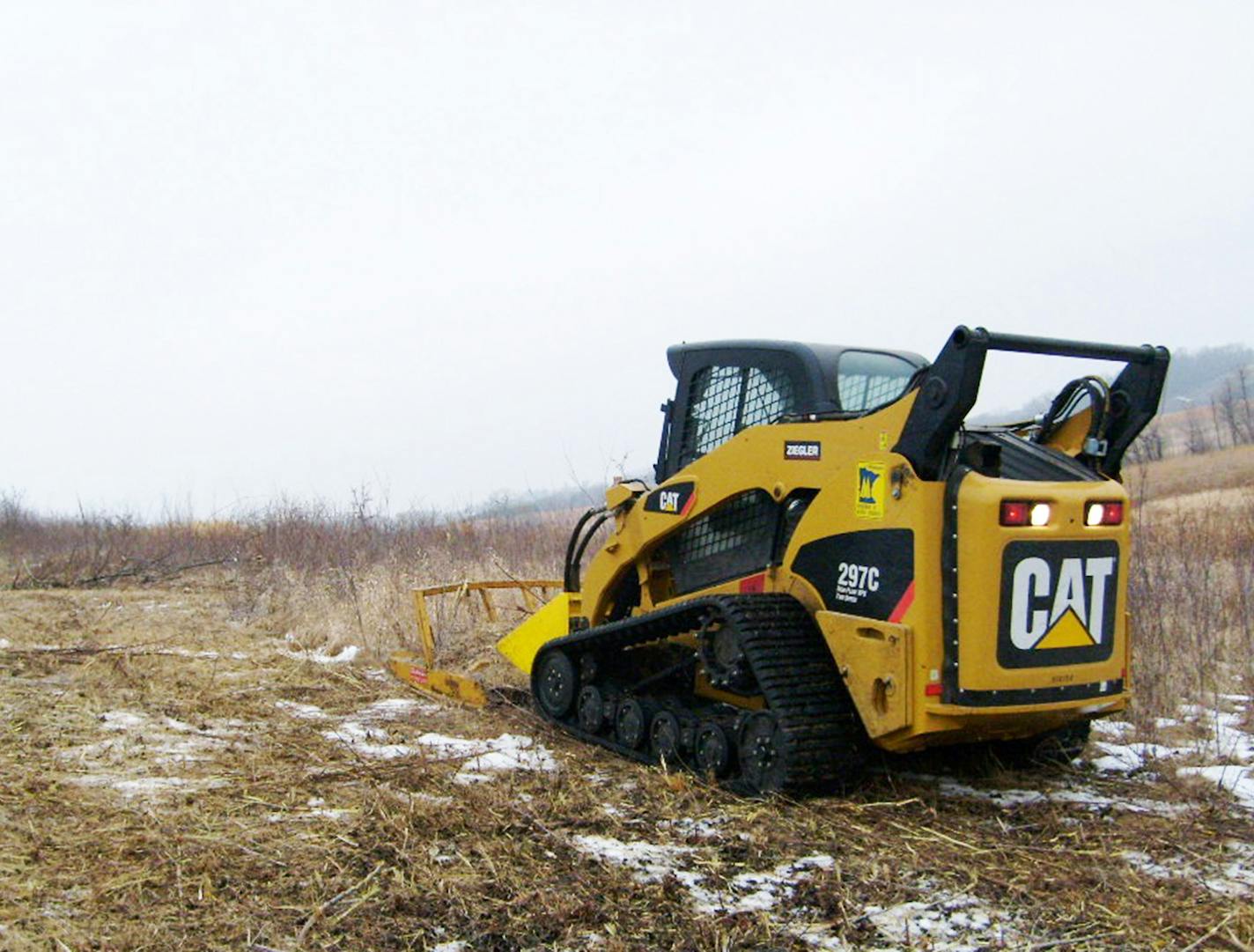 Cutting down trees to save prairie is a major emphasis of prairie wildlife management at the DNR, U.S. Fish and Wildlife Agency and The Nature Conservancy. Here, a DNR crew prepares to clear woody encroachment into grasslands at the Ney and Bradshaw Wildlife Management Area in Scott County. Photo courtesy DNR