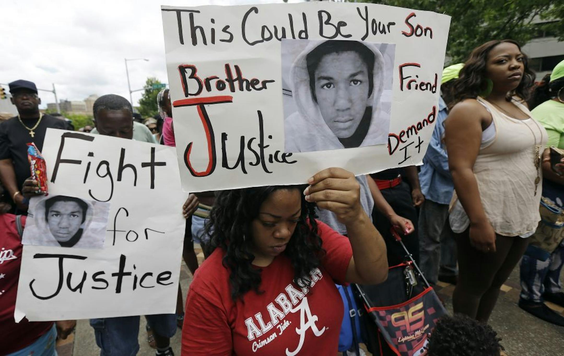 Keta Taylor, center, of Birmingham, Ala., joins about 500 other demonstrators during a rally and march in support of Trayvon Martin in Birmingham, Ala., Monday.