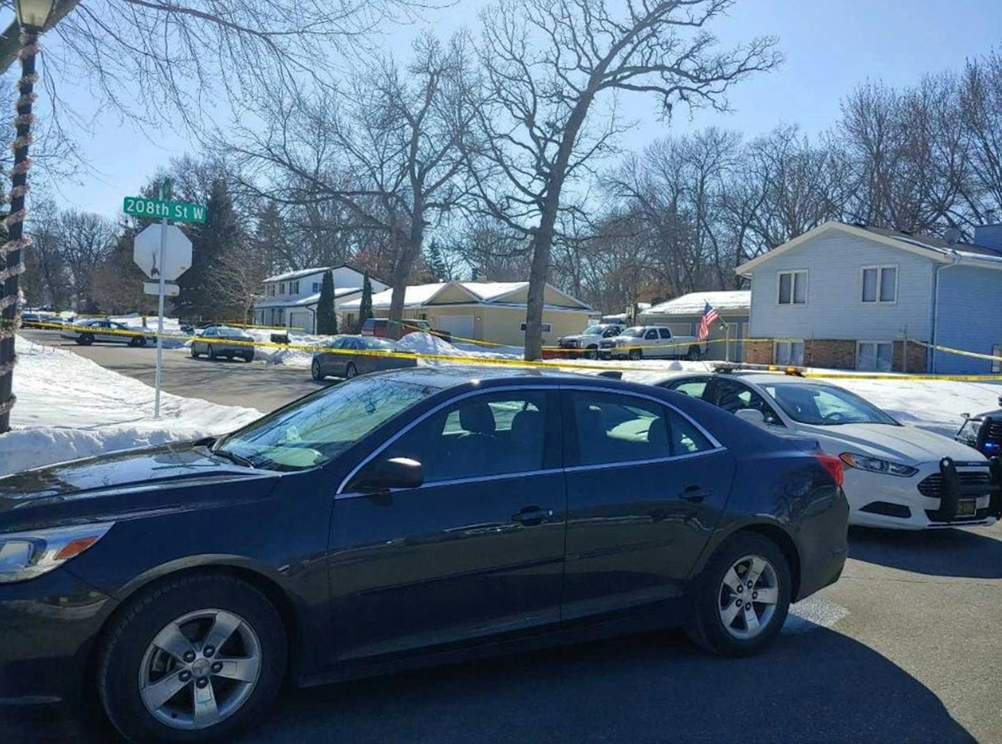 Crime scene tape surrounded the yellow home where a man was fatally shot by Dakota County deputies serving a search warrant in Lakeville.