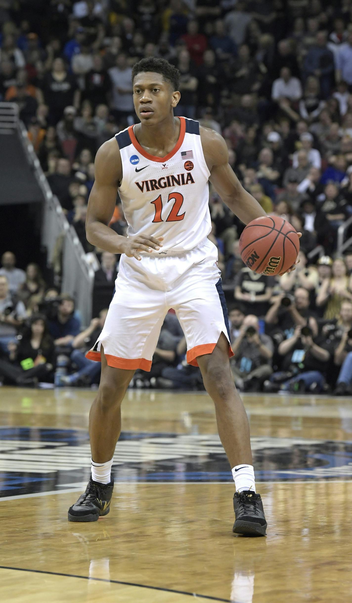 Virginia's De'Andre Hunter dribbles during the second half of the men's NCAA Tournament college basketball South Regional final game against Purdue, Saturday, March 30, 2019, in Louisville, Ky. (AP Photo/Timothy D. Easley)