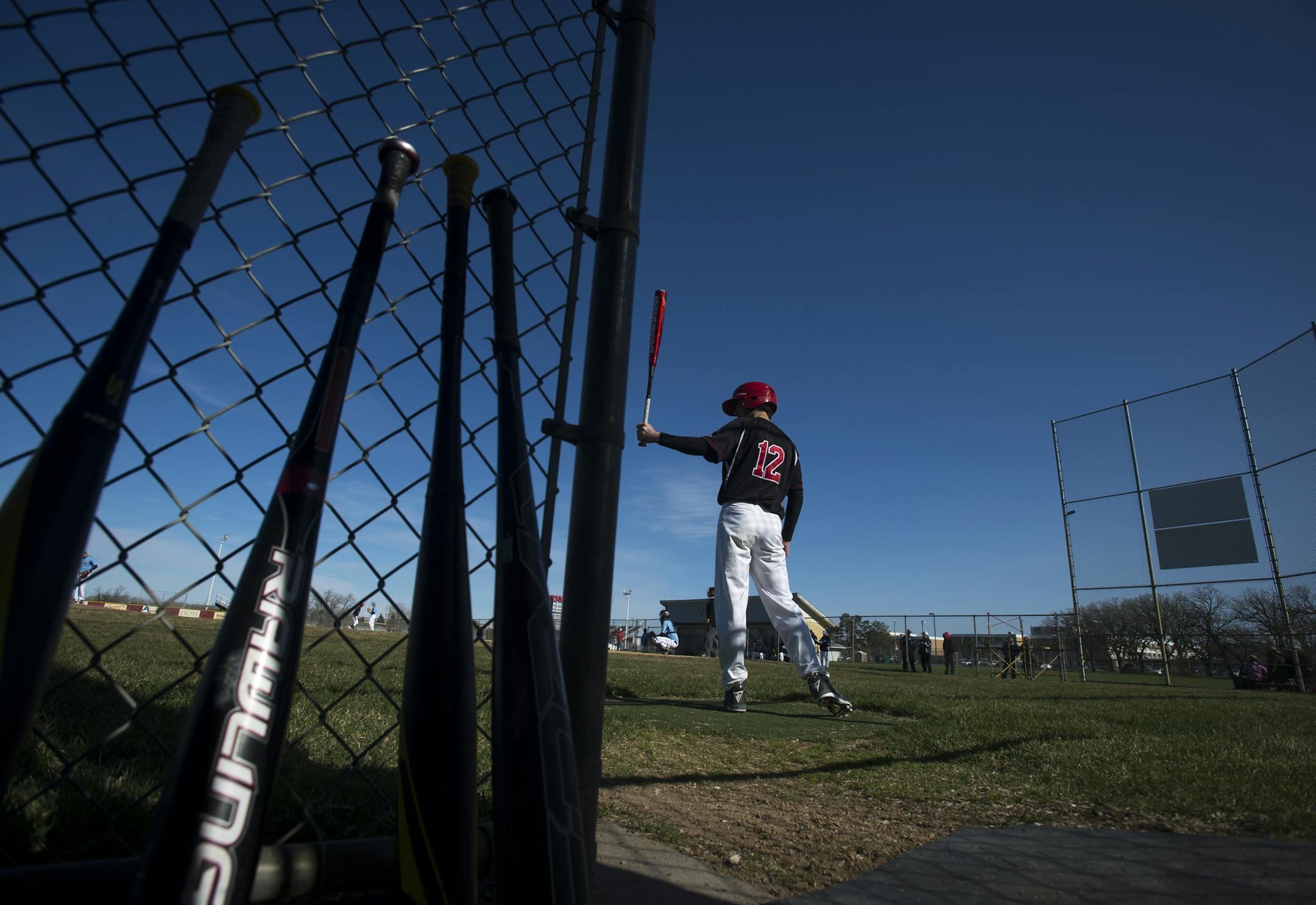 Coon Rapids infielder Brody Lang set up for a practice swing during Wednesday's home game against Blaine. Despite plenty of doom and gloom reports about declining interest in baseball from kids, the sport is booming in Coon Rapids, with five teams from varsity down to two freshman teams.