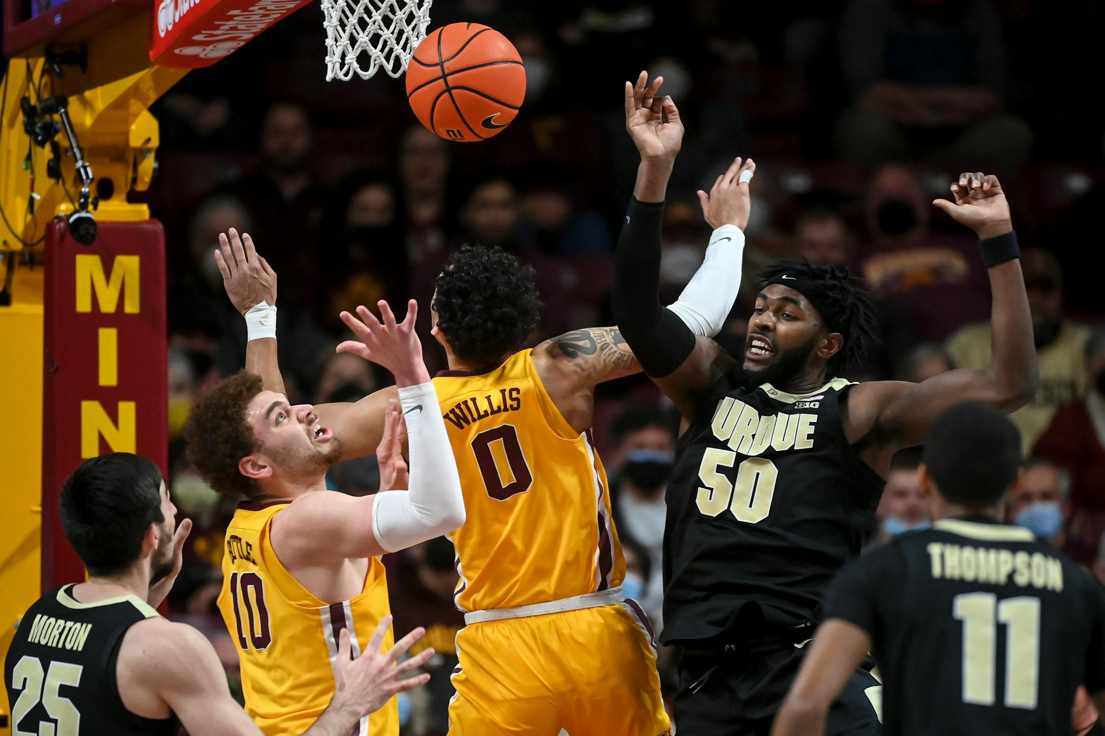 Purdue Boilermakers forward Trevion Williams (50) is called for a foul during an offensive rebound against Minnesota Gophers guard Payton Willis (0) during the first half of an NCAA men's basketball game between Minnesota and Purdue at Williams Arena in Minneapolis, Minn.
