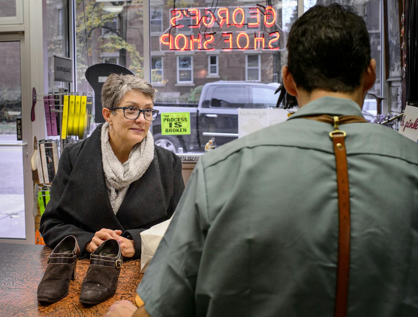 Eileen Quinlan dropped off a pair of shoes at George's Shoe Repair along Grand Avenue, St. Paul. Chris George, right, said it would be terrible for his customers to have to pay for parking when most dash in and out in a few minutes. ] GLEN STUBBE * gstubbe@startribune.com Thursday October 29, 2015 Following report that the city of St. Paul may be dropping its proposal to install parking meters on Grand Avenue, in the face of widespread community opposition. Looking for a nice, overview shot of G