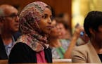 State Rep. Ilhan Omar, a DFL candidate for Congress, sat during new city council member Mitra Jalali Nelson's swearing in at St. Paul City Hall. ] ANT