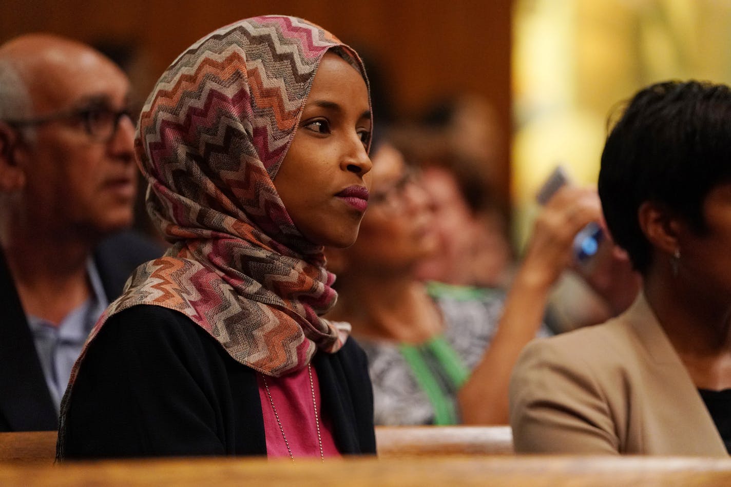 State Rep. Ilhan Omar, a DFL candidate for Congress, sat during new city council member Mitra Jalali Nelson's swearing in at St. Paul City Hall. ] ANTHONY SOUFFLE &#xef; anthony.souffle@startribune.com New St. Paul City Council member Mitra Jalali Nelson was sworn in as the new Fourth Ward City Council member Wednesday morning City Hall in St. Paul, Minn.