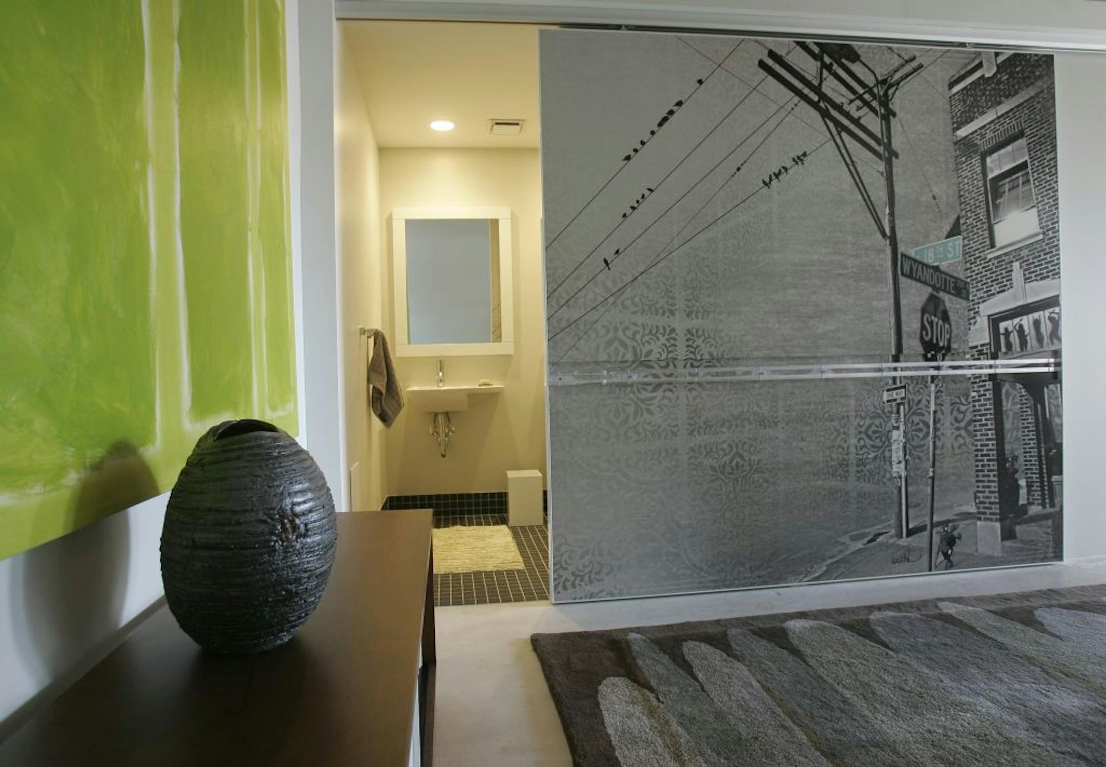Joe Munson, a furniture designer and fabricator, made sliding metal doors for the bathrooms in this condo of Stephen and Sarah Hopkins.