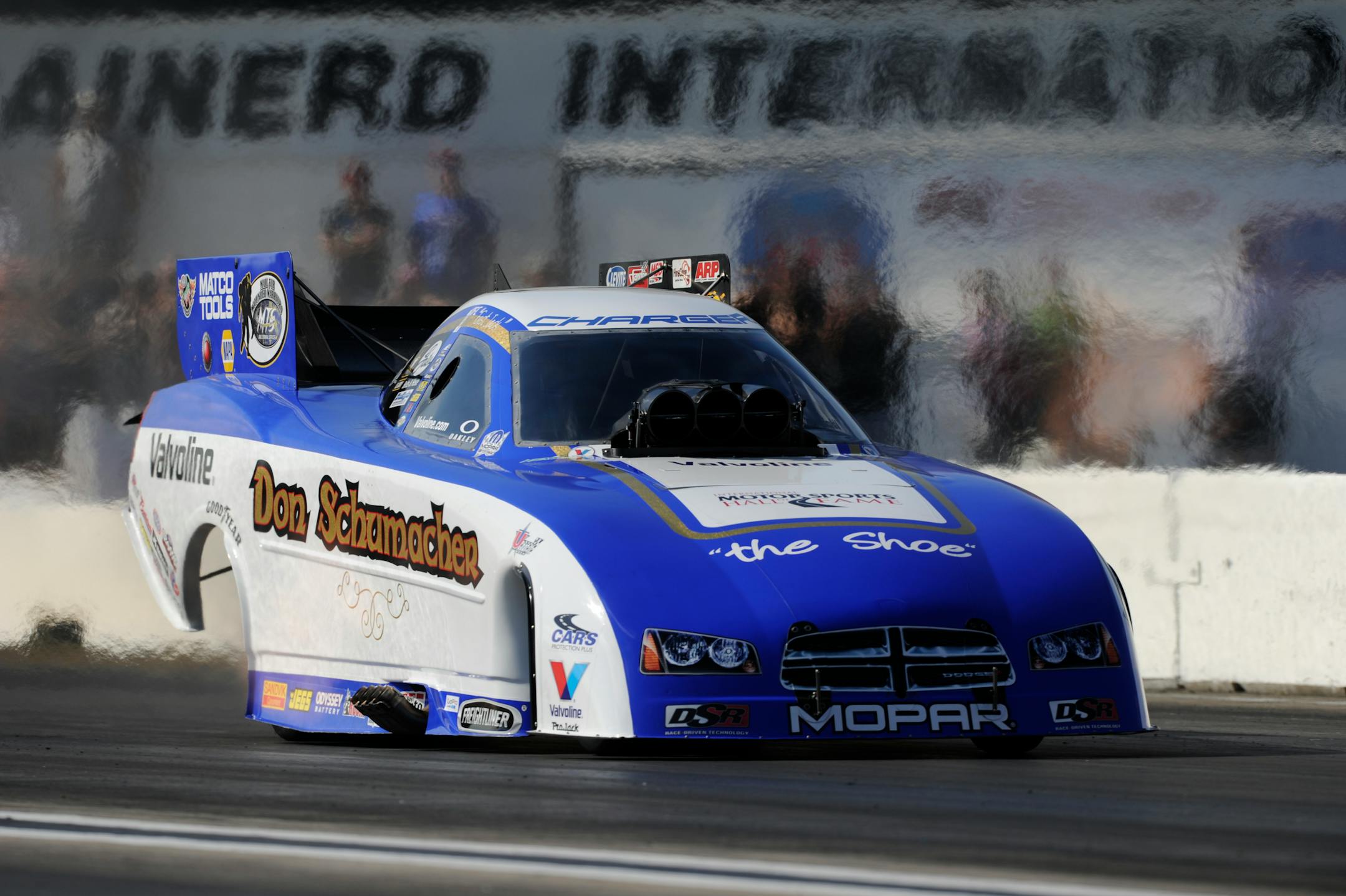 In this photo provided by NHRA, Funny Car driver Jack Beckman goes down the track during qualifying on Saturda in his new Don Schumacher Hall of Fame Tribute Dodge Charger at the Lucas Oil NHRA Nationals drag races at Brainerd International Raceway.