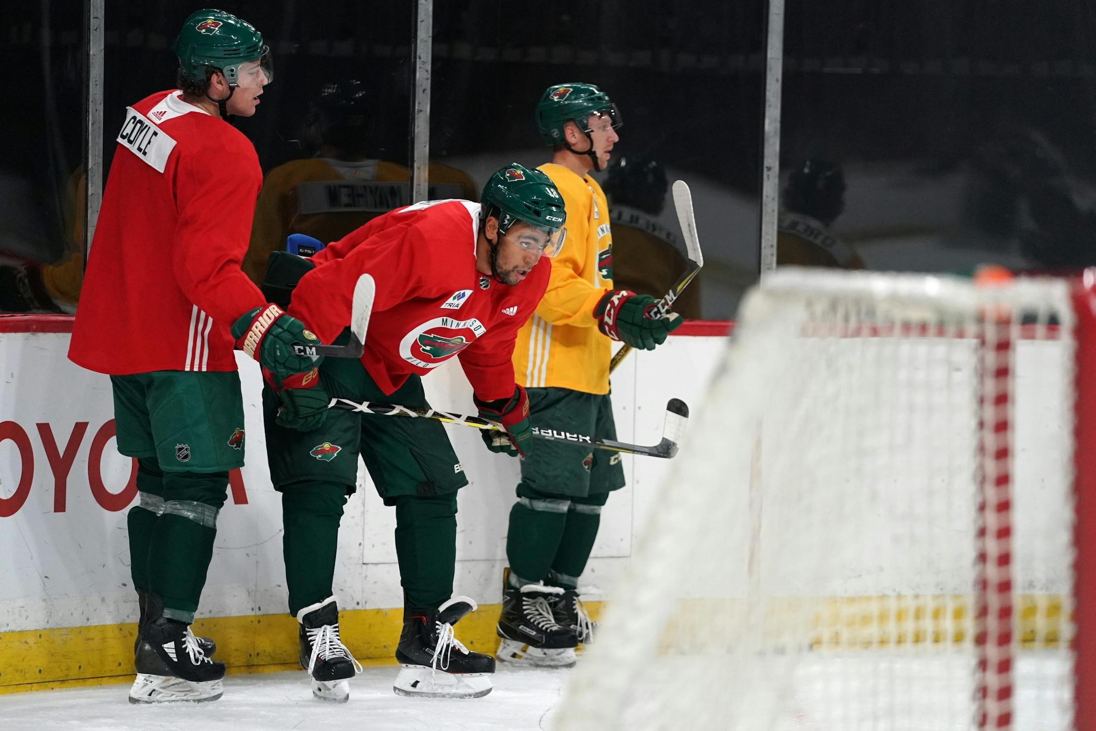 Minnesota Wild center Charlie Coyle (3) and Minnesota Wild left wing Jordan Greenway (18) waited between drills.