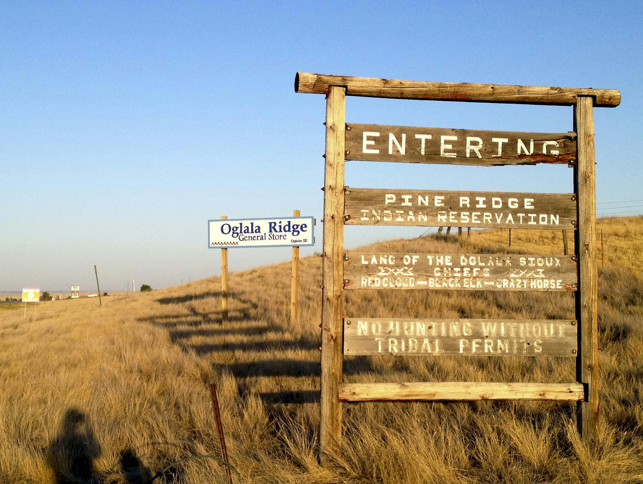 FILE - This Sept. 9, 2012 file photo shows the entrance to the Pine Ridge Indian Reservation in South Dakota, home to the Oglala Sioux tribe. Five more American Indian tribes in South Dakota are seeking federal money to help operate their own foster care programs. The Rosebud Sioux in 2013 became one of the first tribes in the nation to receive a $300,000 planning grant. The Oglala and Crow Creek Sioux, Standing Rock, Cheyenne River, and Yankton tribes this week also submitted applications for g