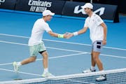 Max Exsted, left, and Cooper Woestendick celebrated a point during the final in boys doubles at the Australian Open.