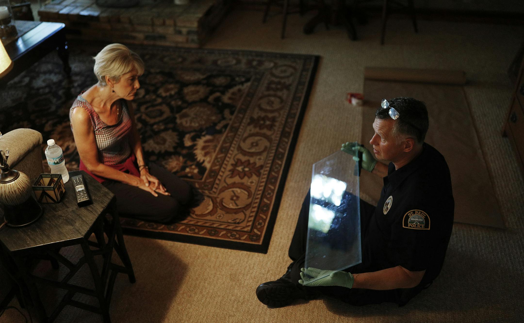 St. Paul police officer Mark Lundquist right , explained to Shari Wagner the finger printing process as he removed a glass panel form a cabinet at the home of Shari and Eric Wagner July 2, 2018 in Mendota Heights, MN. The Wagnerís one and half year old grandson Abraham Flynnís died in a tragic accident last April. His grandmother shorty discovered his left hand print after his death. Shari Wagner said that she would use his fingerprint for a possible jewelry piece. ] JERRY HOLT ï