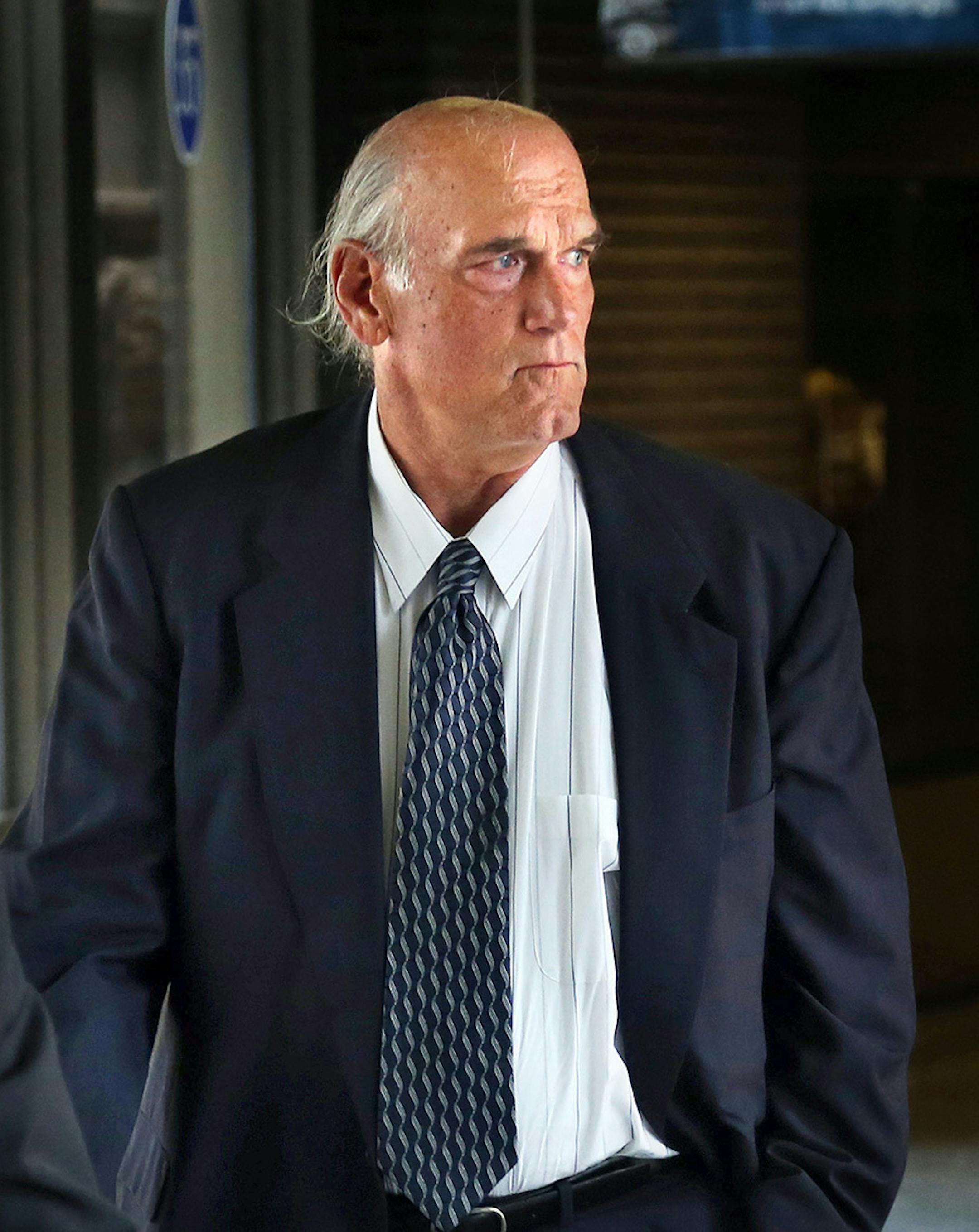 Former Minnesota Gov. Jesse Ventura makes his way back into Warren E. Burger Federal Building during the first day of jury selection in a defamation lawsuit, Tuesday, July 8, 2014 in St. Paul, Minn. Ventura filed the defamation lawsuit against the late Navy Seal Chris Kyle's estate, claiming that Kyle's account of a bar fight in a book he wrote was false.