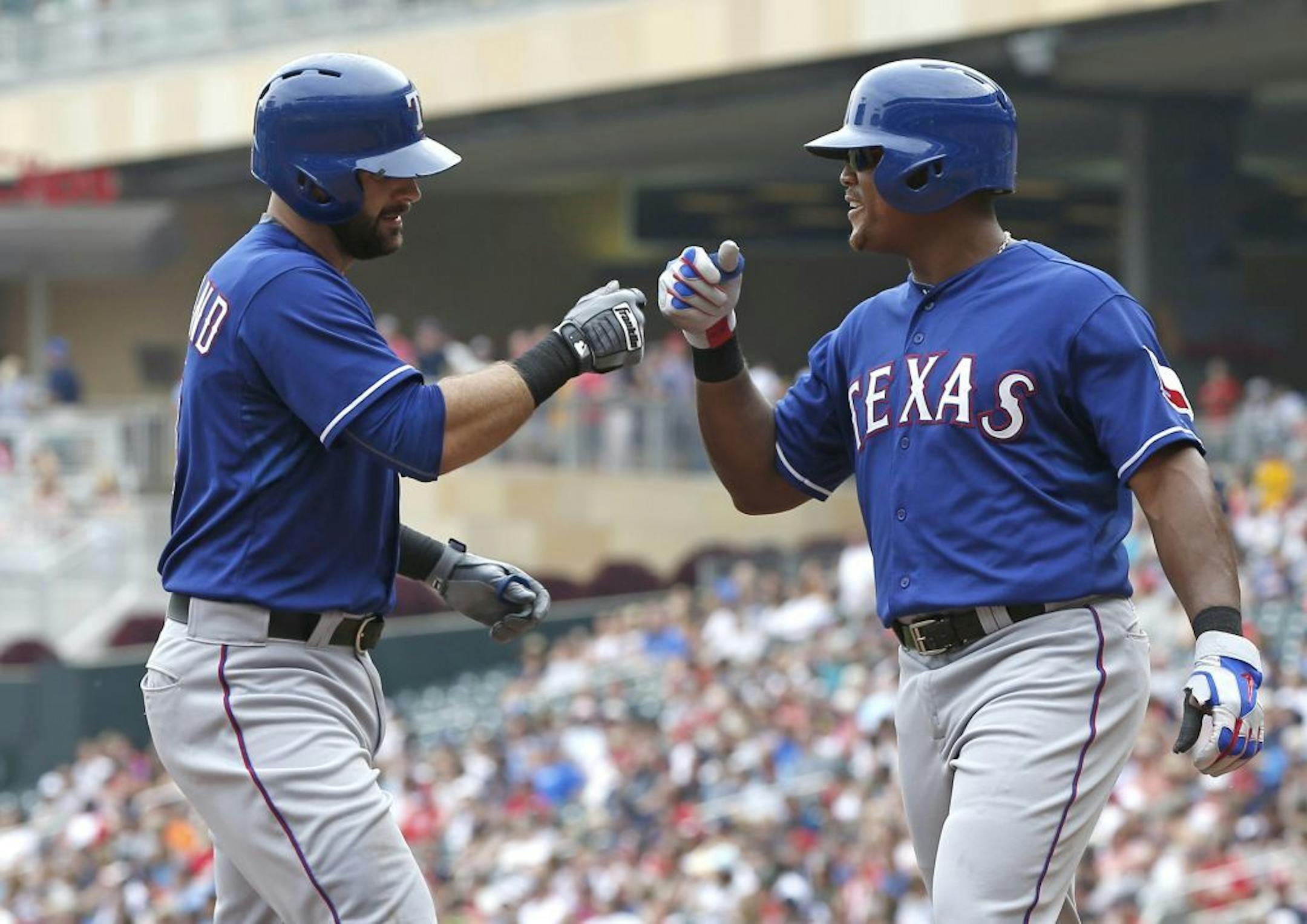 Mitch Moreland, left, is congratulated by Adrian Beltre following his two-run home run off Minnesota Twins pitcher Ervin Santana in the fourth inning of a baseball game, Thursday, Aug. 13, 2015, in Minneapolis.